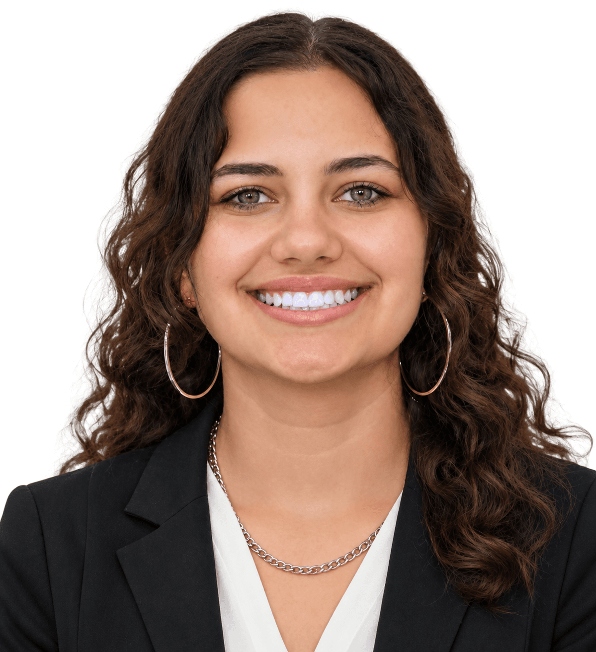 Smiling woman with curly brown hair and green eyes wearing a black blazer and necklace.